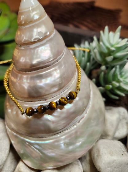 Bracelet ref 73 : Cordon réglable Œil de tigre  Cordon tressé doré